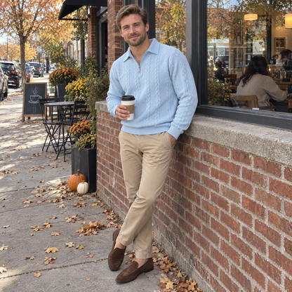 Man outside a café in the light blue Bleamme Collared Cable Quarter Zip with tan chinos and loafers